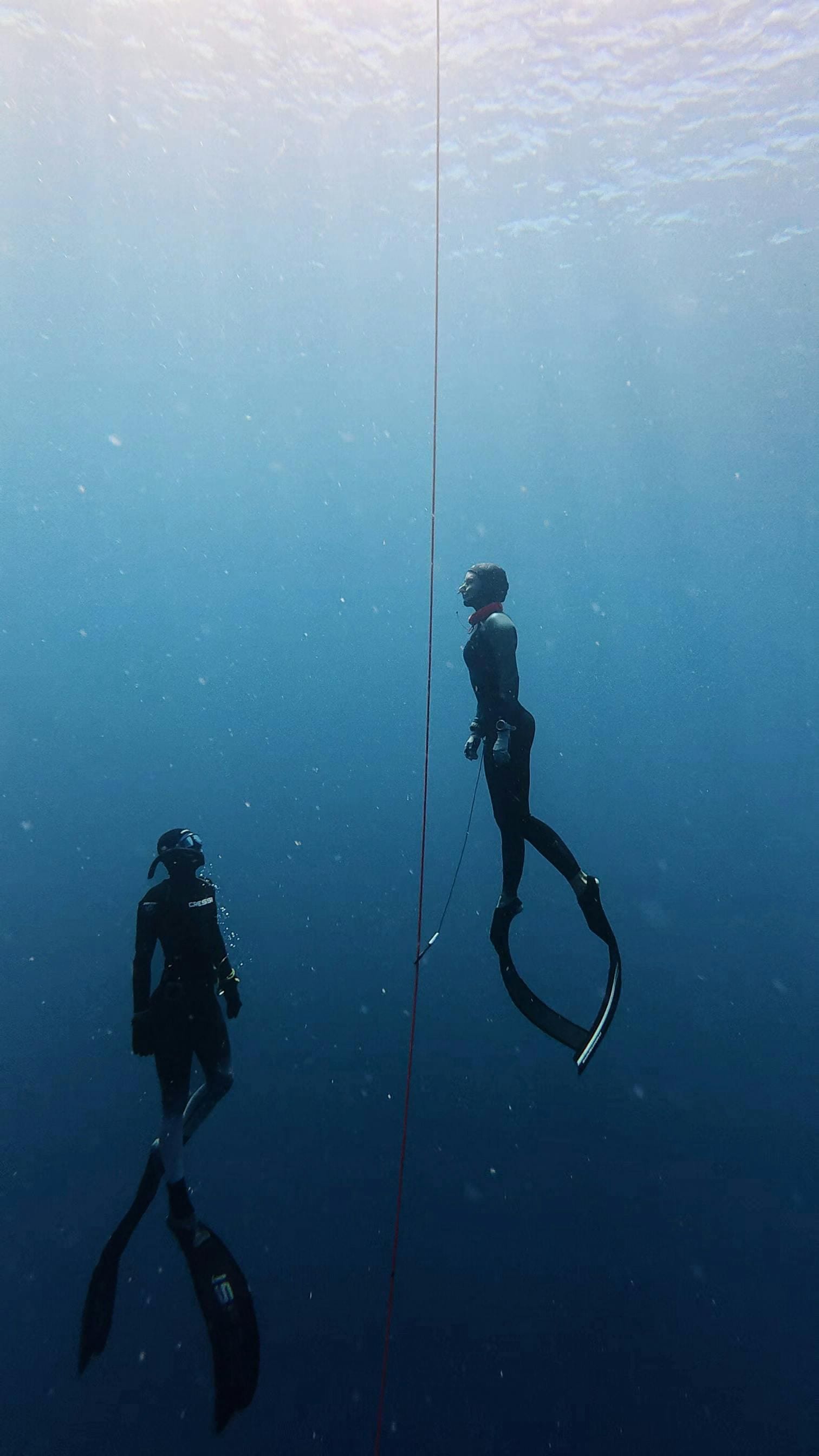 Two freedivers at the line in the deep blue off Gili Air