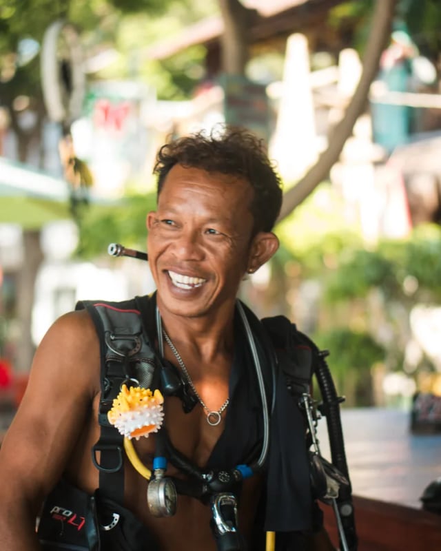 A Moana Dive Air crew member smiling in scuba gear