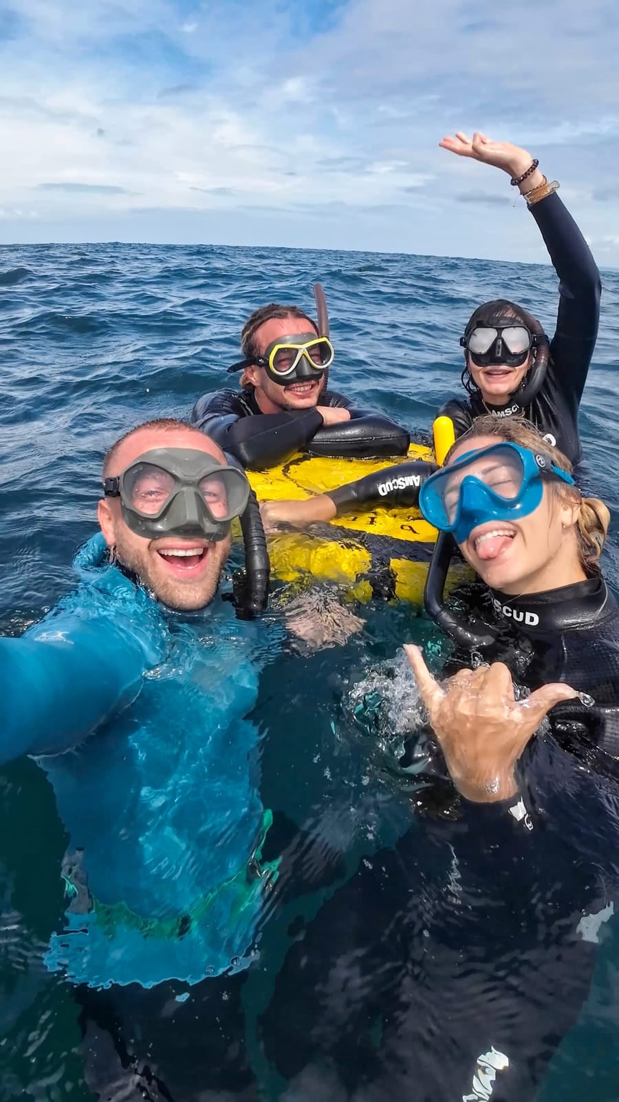 Freedivers smiling at the surface around the buoy