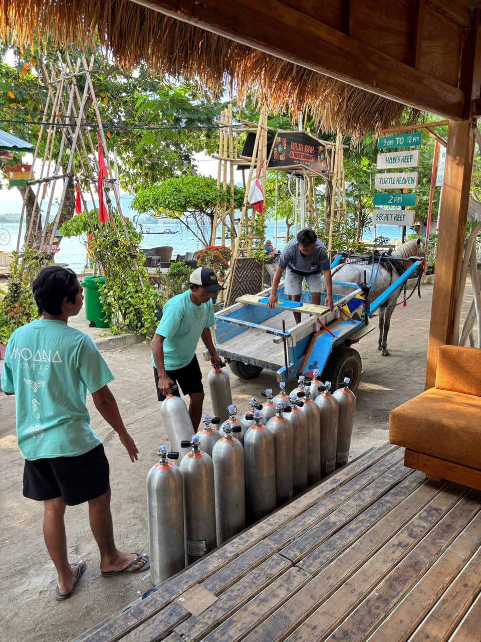 The Moana crew loading scuba tanks onto a traditional horse cart on Gili Air