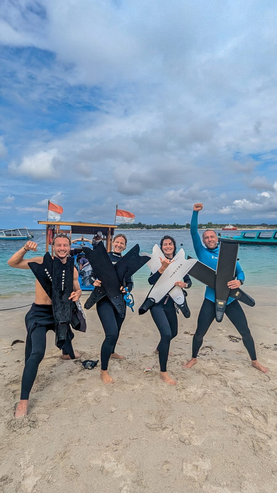 The freedive crew with their fins on the beach